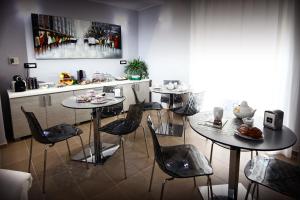 a kitchen with two tables and chairs with food on them at La Corte del Geco in Crotone