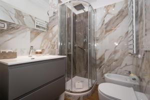a bathroom with a shower and a toilet and a sink at La Genziana in Rome +65 photos