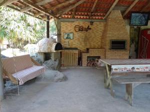 an outdoor patio with a pizza oven in a building at Sítio com piscina em Caldas da Imperatriz in Santo Amaro da Imperatriz