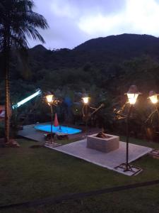 a view of a swimming pool at night at Sítio com piscina em Caldas da Imperatriz in Santo Amaro da Imperatriz +21 photos