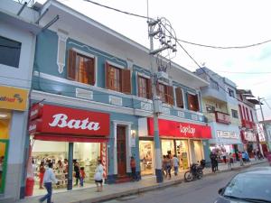 a group of shops on a city street with people walking around at Casa Mendoza in Sullana