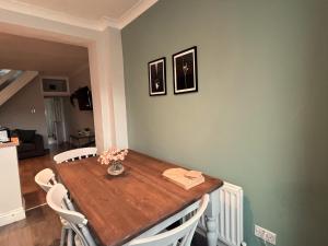 a dining room table with chairs and flowers on it at Durham 3 Bedroom House With Parking in Durham +26 photos