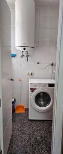 a kitchen with a washing machine in a room at Paradise of Dreams Apartamentos - LA CARRERA in Adra