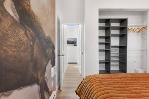 a bedroom with a bed and a book shelf at Hot Tub 4 Baths 4 Bedrooms Montana Themed Bikes in Livingston