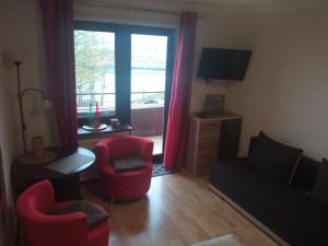 a living room with a couch and chairs and a window at Komfortowy pokój gościnny 300 m od morza dzielnica uzdrowisk in Kołobrzeg +7 photos