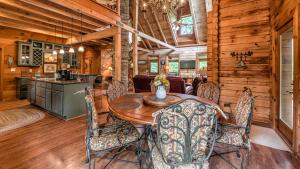 a dining room with a table and chairs in a cabin at Fightingtown Creek Retreat in McCaysville