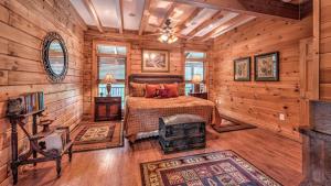 a bedroom with a bed in a room with wooden walls at Fightingtown Creek Retreat in McCaysville