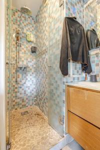 a bathroom with a shower with a glass door at Week-end Porte de Clichy in Clichy +26 photos