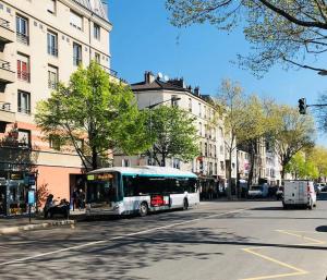 a bus is driving down a city street at Week-end Porte de Clichy in Clichy