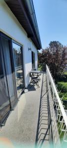 a balcony of a house with a table and windows at FeWo Chiemgau in Gstadt am Chiemsee