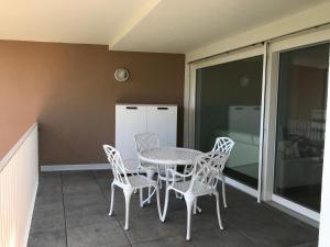 a patio with a table and chairs and a refrigerator at Azalea in Cornaiano +9 photos