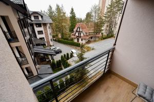 an apartment balcony with a view of a street at Apartment Heart of Zlatibor - Central Residence in Zlatibor