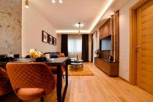 a living room with a dining table and a living room at Apartment Heart of Zlatibor - Central Residence in Zlatibor