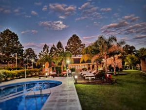 a house with a swimming pool in the yard at H2O Termal primer y unico hotel Kosher de Argentina in Concordia
