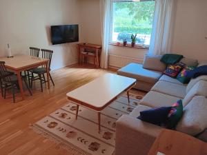 a living room with a couch and a table at BlåKlinten in Mariehamn