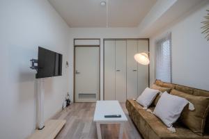 un salon avec un canapé et une table dans l'établissement ディズニーランドまで車で10分 Aim Town 南葛西 Condo-, à Tokyo