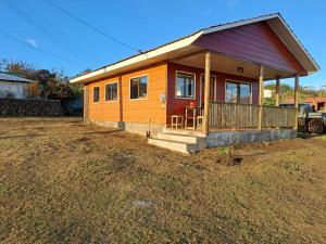 a small house sitting on top of a field at Cabaña Nukutiare in Hanga Roa