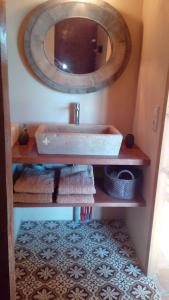 a bathroom with a sink and a mirror at Le Mazet De Jean in Le Cailar