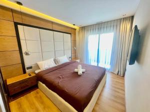 a bedroom with a bed with a teddy bear on it at Golden Sand Apartment - Terrace & OceanView 2BD in Tangier +38 photos