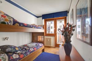 Ένα ή περισσότερα κρεβάτια σε δωμάτιο στο Appartamento Fraiteve Ski In Ski Out 300m - Happy Rentals