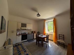 a kitchen with a table and a dining room at Casa Vacanze L'Amedeo in Serrone