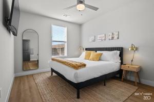 a bedroom with a large bed and a mirror at Trails End Here, Pool, King Beds, Gym, Lux Apt in Rogers +39 photos