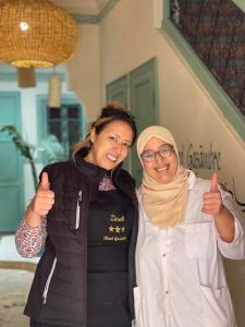 two women giving the thumbs up gesture at Riad Gasämbre Touareg in Marrakesh +45 photos