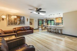 a living room with a couch and a table at 4 Mi to Beach Pet-Friendly Home in Naples! in Naples