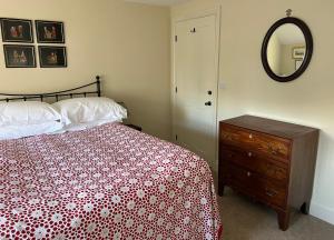 a bedroom with a bed and a dresser and a mirror at Woodward Farm House in Appleton le Moors +25 photos