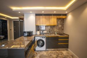 a kitchen with a washing machine and a sink at ISTANBUL SUITE in Istanbul