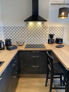 a kitchen with a counter and a stove top oven at Marianne 3 in Bergerac