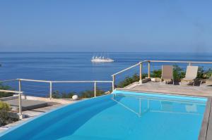 a swimming pool with the ocean in the background at Infiniti Blue in Bouillante