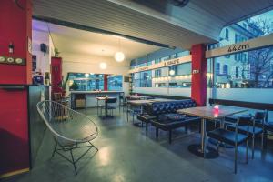 a restaurant with tables and chairs in a room at Bettstatt-Neustadt in Lucerne
