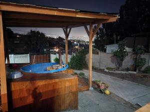 a hot tub under a wooden pergola at Cabañas Martina in Cartagena
