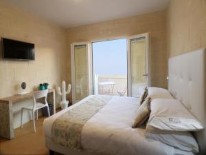 Letto o letti in una camera di GozoWindmill Apartments