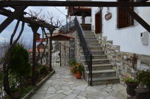 a set of stairs leading up to a house with a gate at Villa Dryanouvaina in Portaria