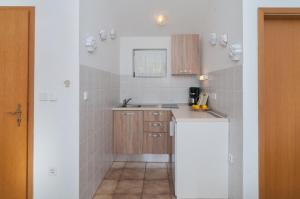a small kitchen with a sink and a counter at Apartments Mira in Pučišća