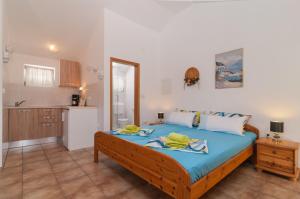 a bedroom with a bed with two people on it at Apartments Mira in Pučišća