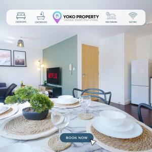 a dining room with a table with plates on it at Beautiful Apartment - Close to City Centre - Free Parking, Fast Wifi, SmartTV with Sky TV and Netflix by Yoko Property in Northampton