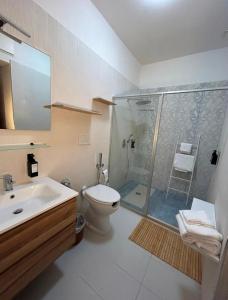 a bathroom with a shower and a toilet and a sink at Bonne Nuit Terracina in Terracina +32 photos