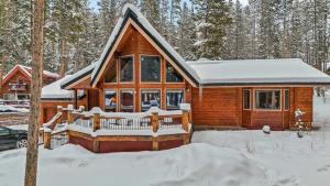 a log cabin in the snow in the woods at Breck Mountain Home Near Main Street and Trails in Blue River
