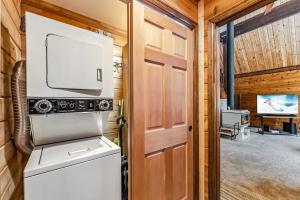 a laundry room with a washer and dryer and a tv at Breck Mountain Home Near Main Street and Trails in Blue River +18 photos