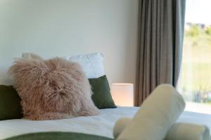 a stuffed animal sitting on top of a bed at Best Day Ever in Wanaka
