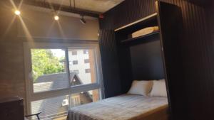 a bedroom with a bunk bed and a window at Tribeca 402 in Gramado