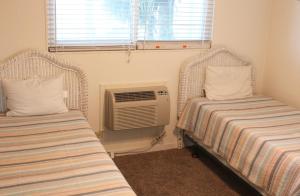 a room with two beds and an air conditioner at Sandy Shores in Myrtle Beach +20 photos