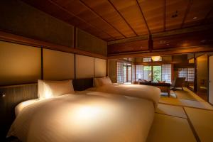 Postel nebo postele na pokoji v ubytování Hotel Utano Kyoto Besho