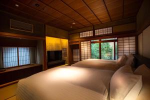 Postel nebo postele na pokoji v ubytování Hotel Utano Kyoto Besho