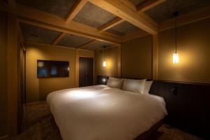 Postel nebo postele na pokoji v ubytování Hotel Utano Kyoto Besho