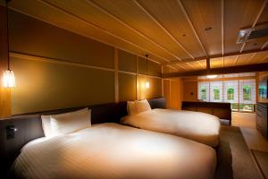 Postel nebo postele na pokoji v ubytování Hotel Utano Kyoto Besho