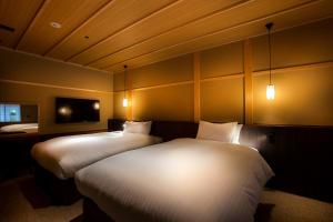 Postel nebo postele na pokoji v ubytování Hotel Utano Kyoto Besho